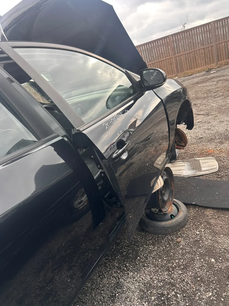 Car with its hood raised and a wheel removed during a mobile service visit